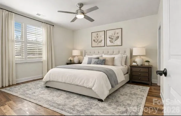 a bedroom with a large bed and a window