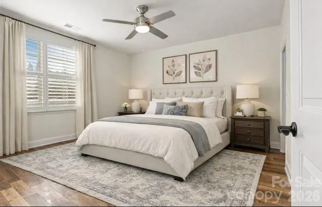 a bedroom with a large bed and a window