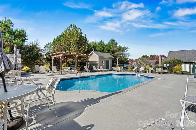 a view of a swimming pool with outdoor seating