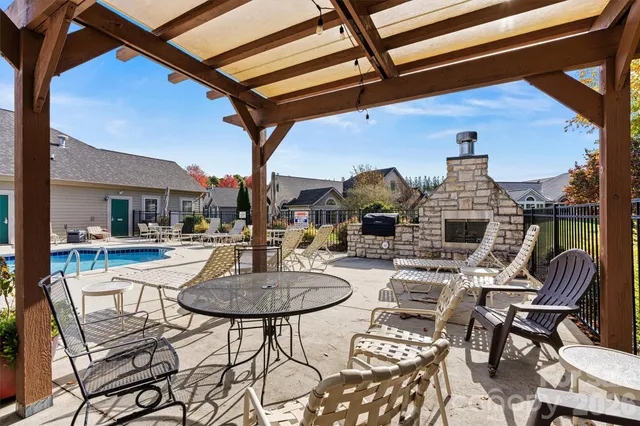 a swimming pool with outdoor seating and yard