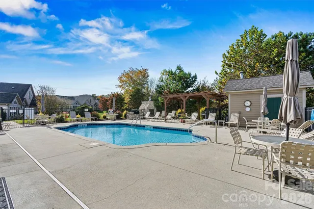 a view of swimming pool with outdoor seating and plants