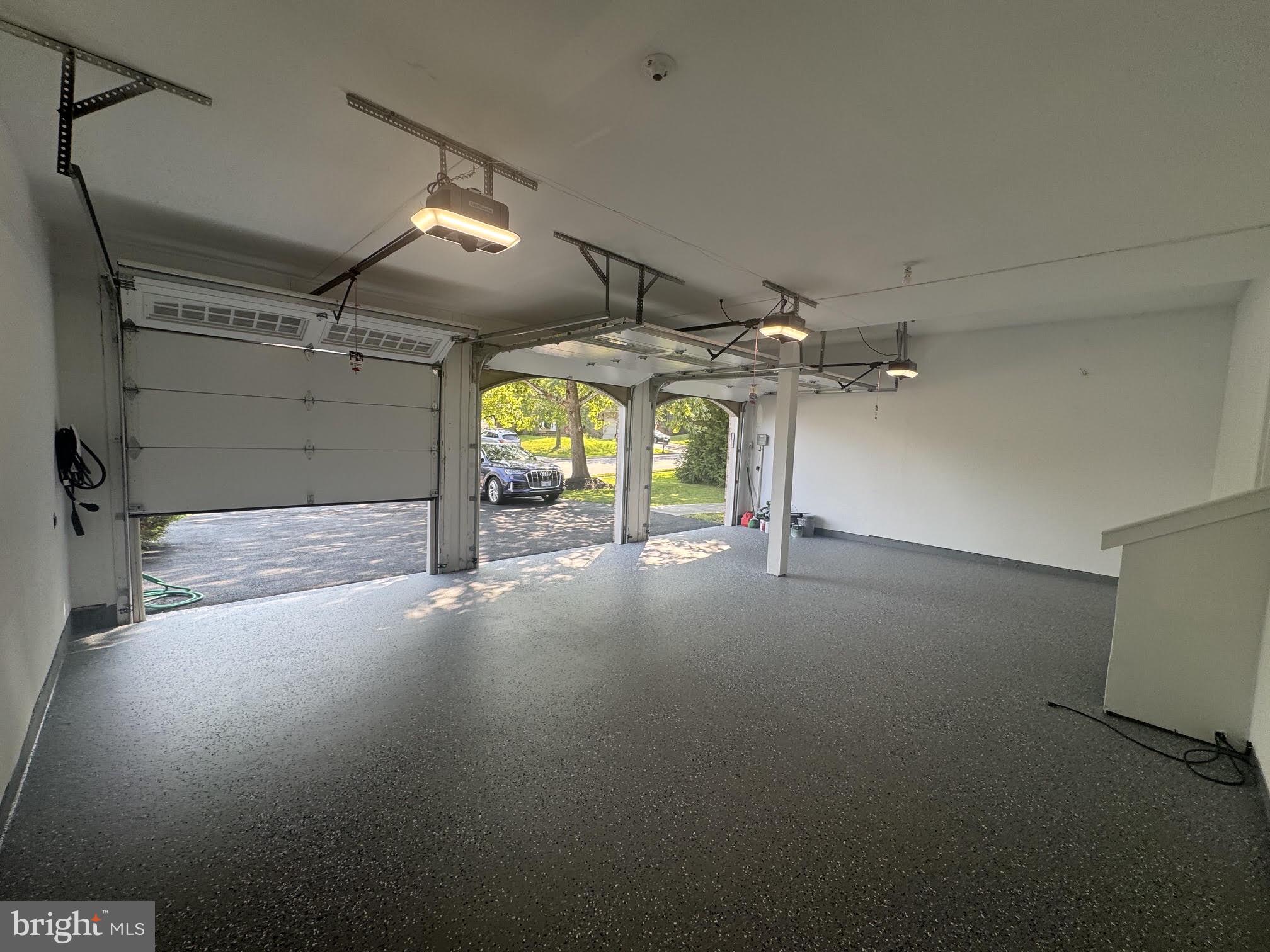18426 Rim Rock Circle Leesburg, VA 20176 - Photo 58 of 60 Spacious garage with modern lighting.