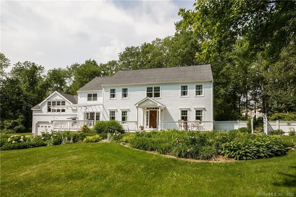76 Benson Road Ridgefield, CT 06877 - Photo 1 of 1 a front view of a house with a yard and green space