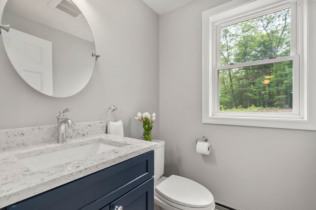 93 Spectacle Hill Road Bolton, MA 01740 - Photo 6 of 42 a bathroom with a granite countertop sink mirror vanity and toilet