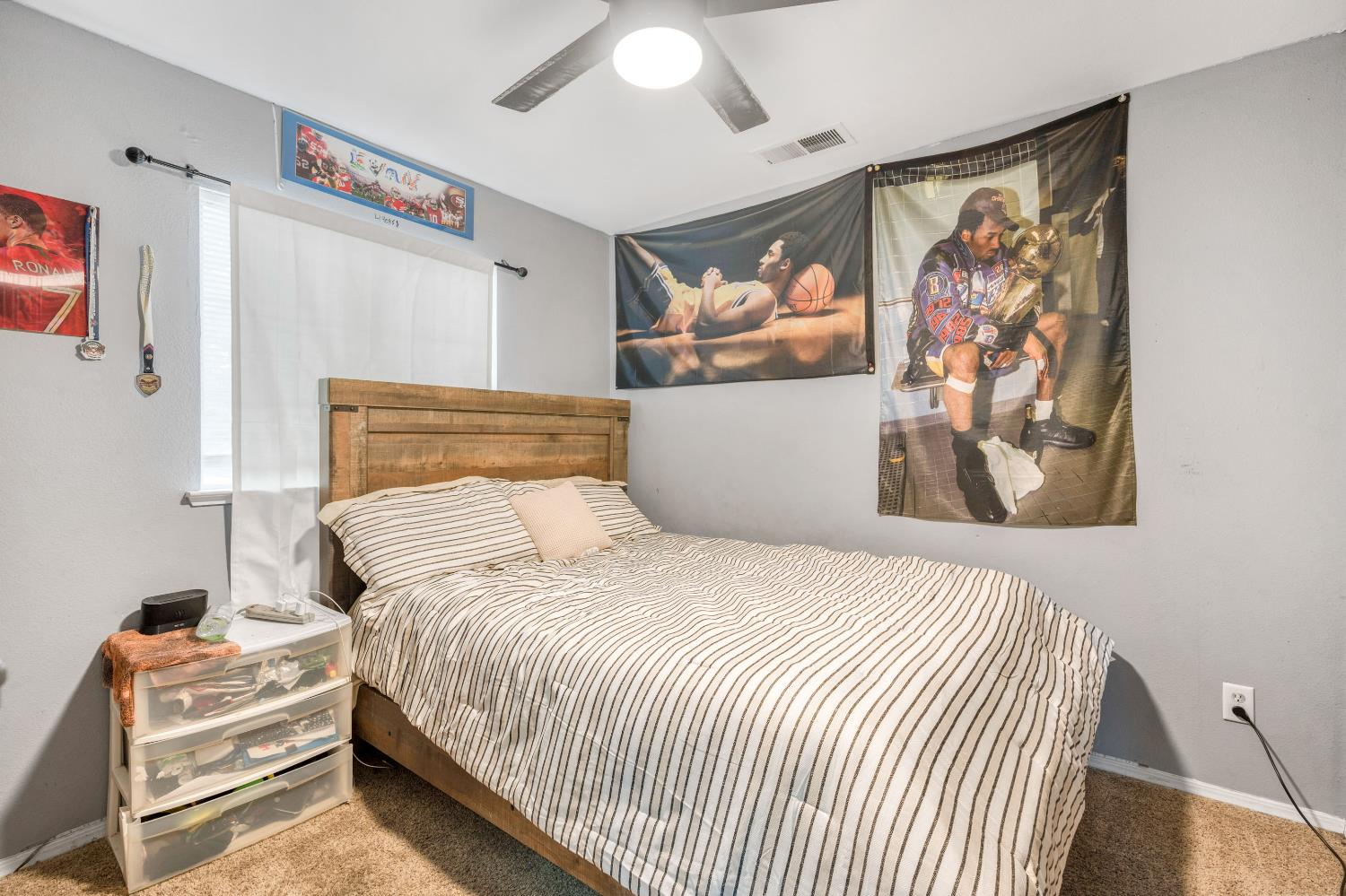 525 Tucker Sanger, CA 93657 - Photo 8 of 13 a bedroom with a large bed and a painting on the wall