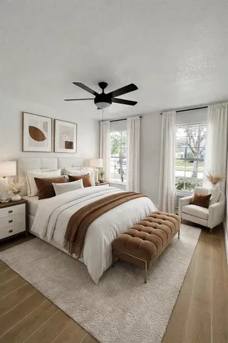 a bedroom with a bed couch and a window