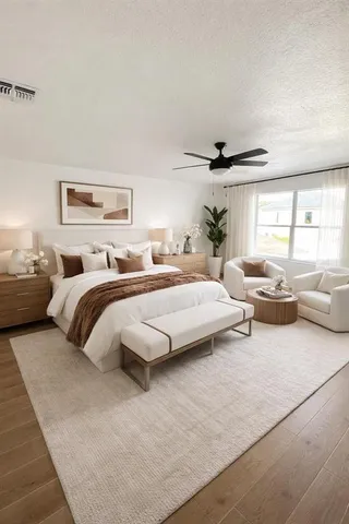 a bedroom with a bed and a large window