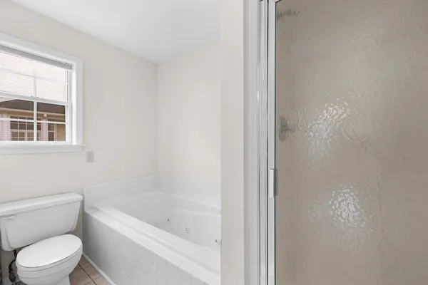 a white toilet sitting next to a bath tub