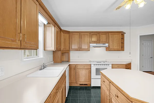 a kitchen with a sink a stove and cabinets