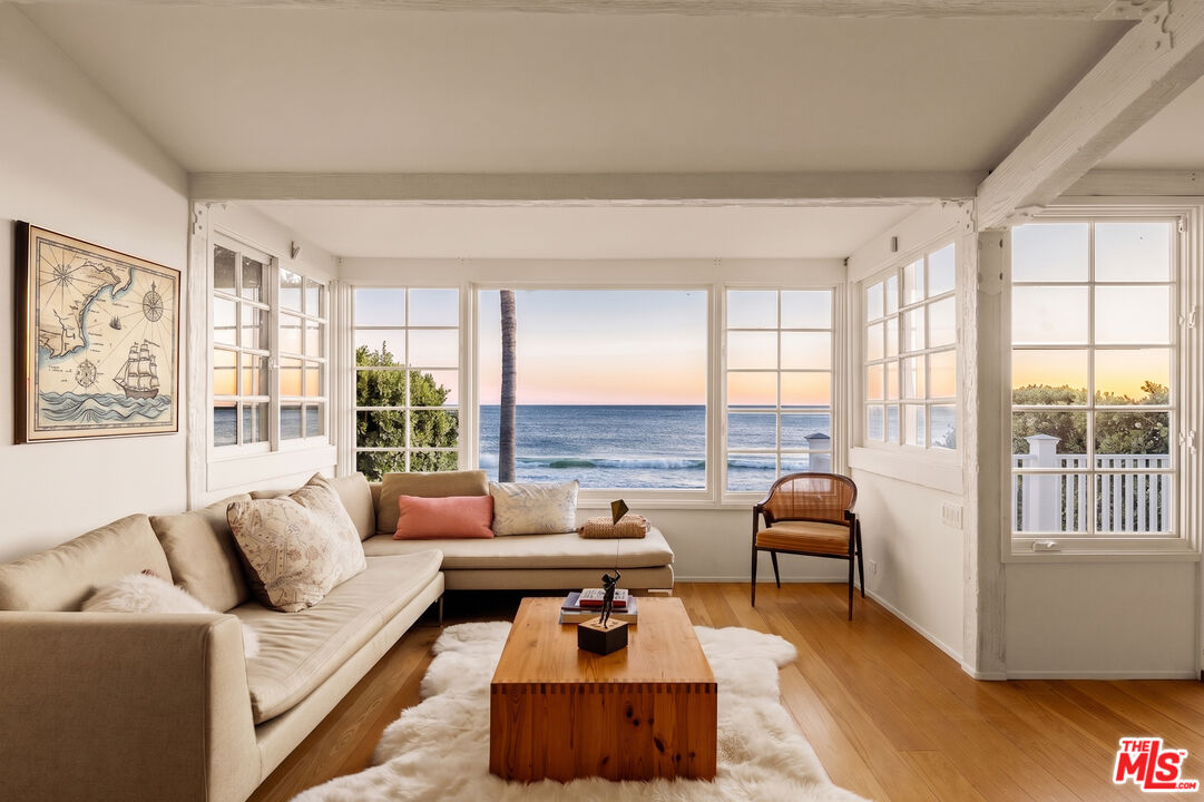 23422 Malibu Colony Road, Unit 98 Malibu, CA 90265 - Photo 33 of 42 a living room with furniture and floor to ceiling windows