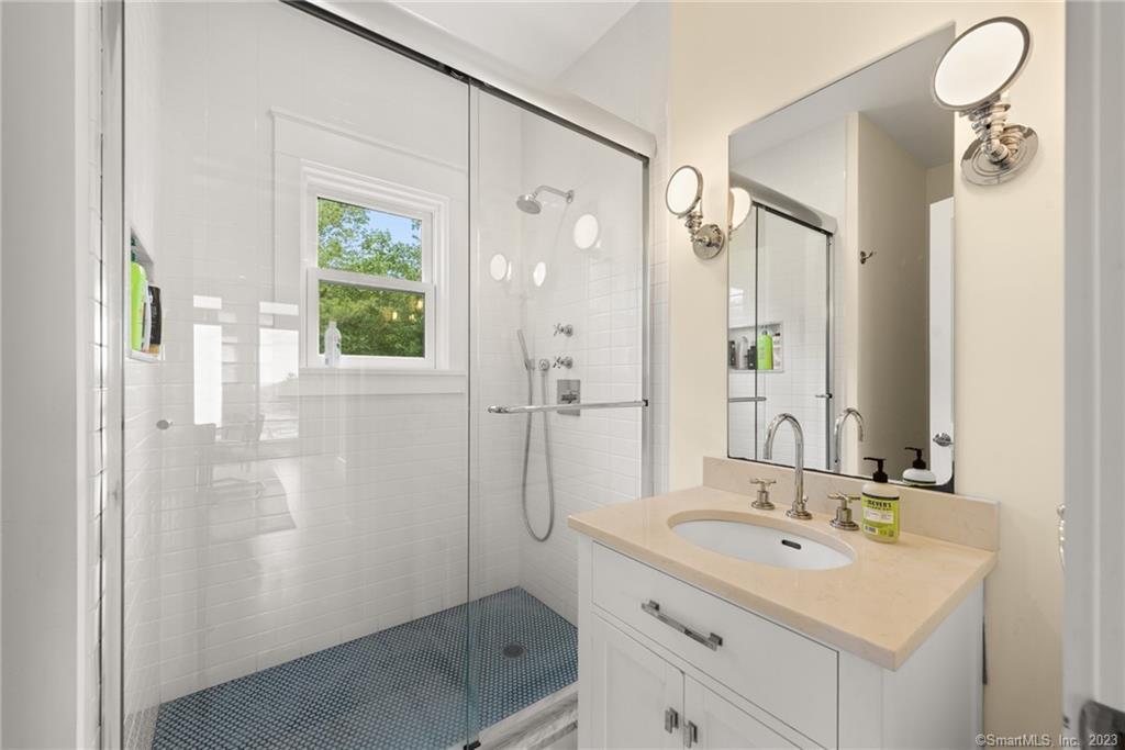 141 Geer Mountain Road South Kent, CT 06785 - Photo 17 of 33 a bathroom with a sink a mirror a vanity and a shower