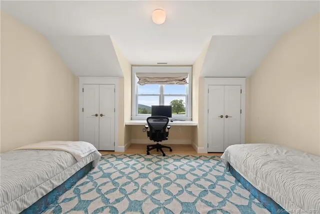 a bedroom with a bed and chair