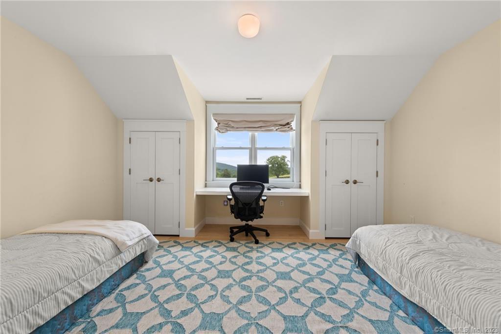 141 Geer Mountain Road South Kent, CT 06785 - Photo 19 of 33 a bedroom with a bed and chair