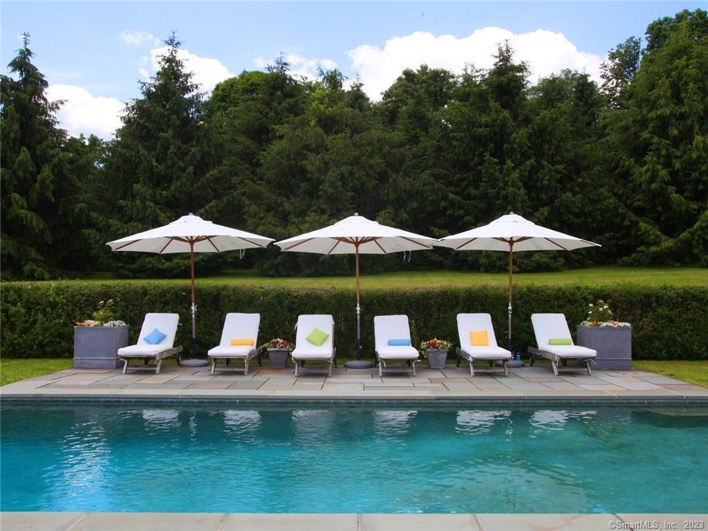 141 Geer Mountain Road Kent, CT 06785 - Photo 2 of 33 a view of a table and chairs under an umbrella