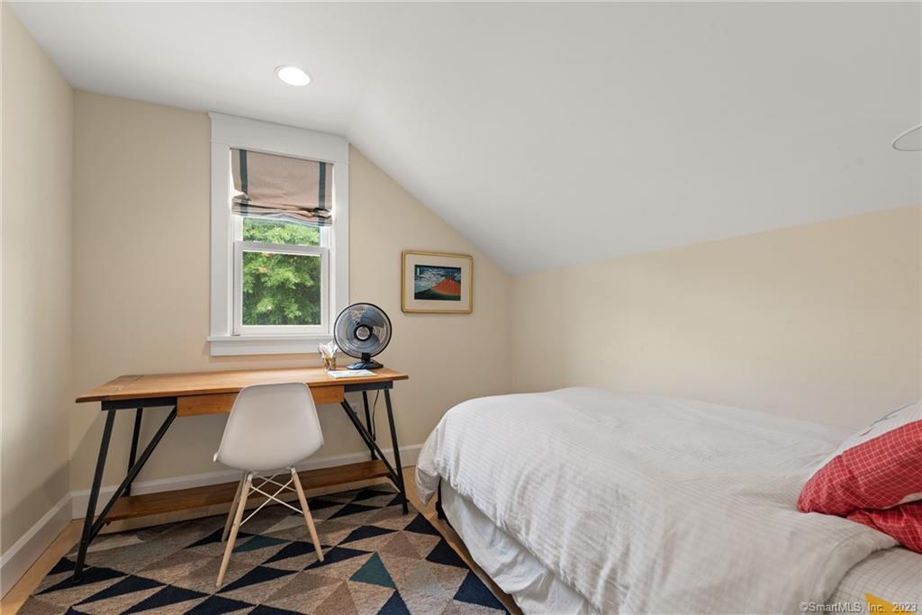 141 Geer Mountain Road South Kent, CT 06785 - Photo 21 of 33 a bedroom with a bed and a table in it
