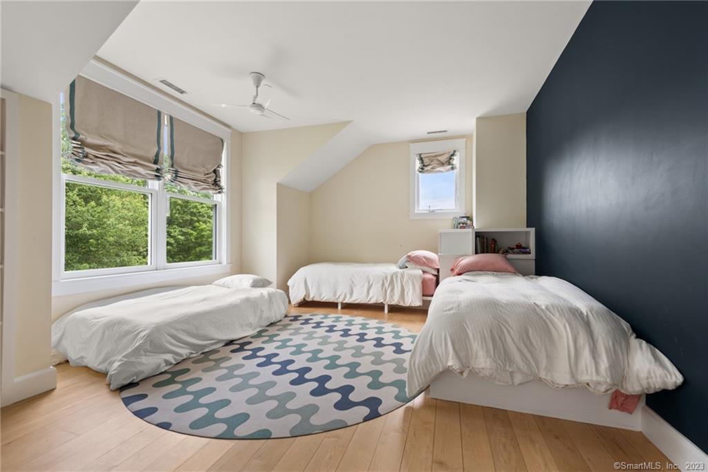 141 Geer Mountain Road South Kent, CT 06785 - Photo 22 of 33 a bedroom with a bed and wooden floor