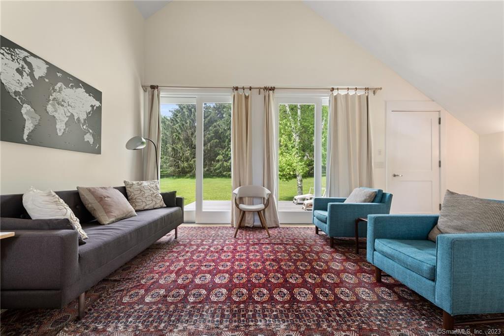 141 Geer Mountain Road South Kent, CT 06785 - Photo 26 of 33 a living room with furniture and large windows