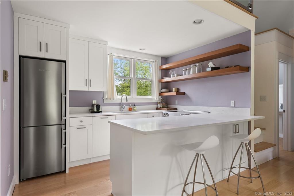 141 Geer Mountain Road South Kent, CT 06785 - Photo 28 of 33 a kitchen with kitchen island a sink stove and refrigerator