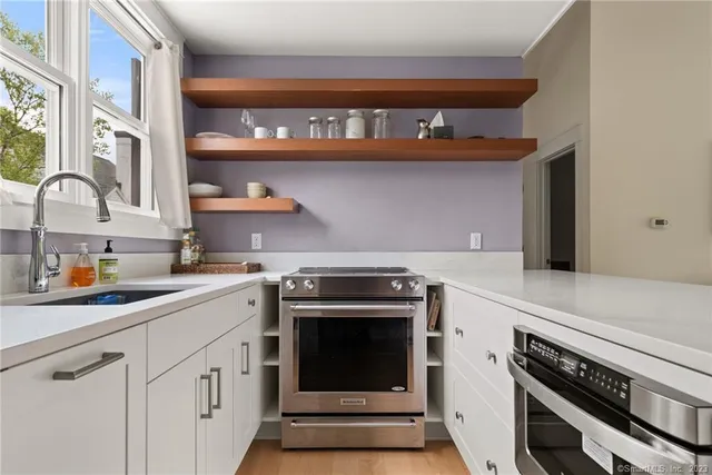 a kitchen with stainless steel appliances granite countertop a stove and a sink
