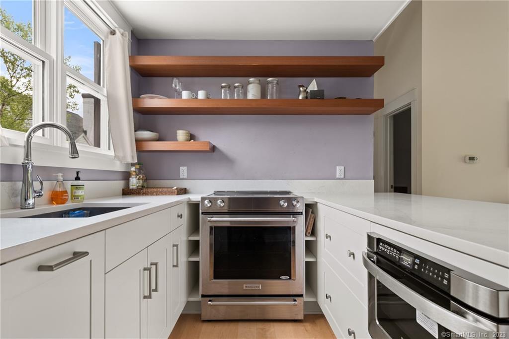 141 Geer Mountain Road South Kent, CT 06785 - Photo 29 of 33 a kitchen with stainless steel appliances granite countertop a stove and a sink