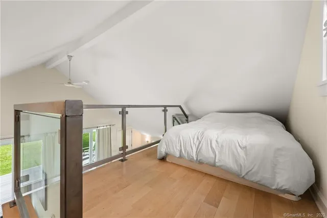 a large bed sitting in a room next to a window
