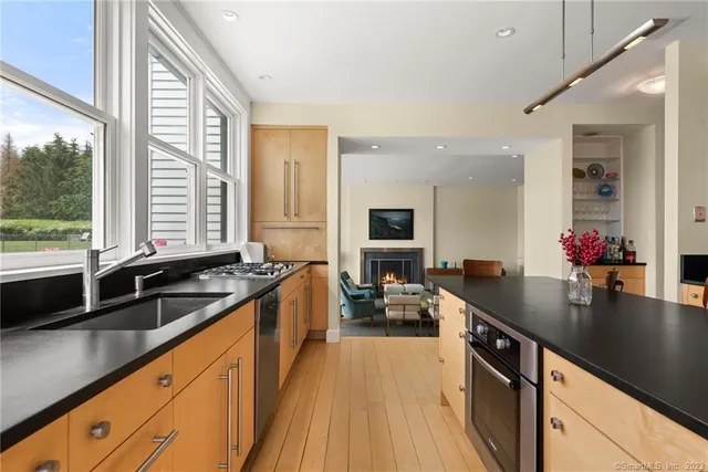 a kitchen with sink stove and refrigerator