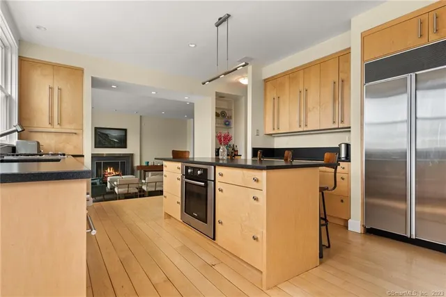 a kitchen with stainless steel appliances granite countertop a refrigerator a stove and a sink