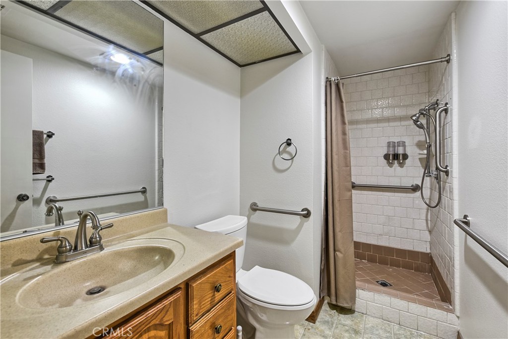 5555 Canyon Crest Drive, Unit 1F Riverside, CA 92507 - Photo 11 of 27 a bathroom with a sink toilet and shower