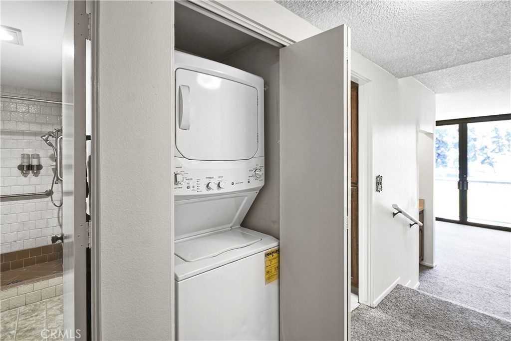 5555 Canyon Crest Drive, Unit 1F Riverside, CA 92507 - Photo 12 of 27 a utility room with dryer and washer