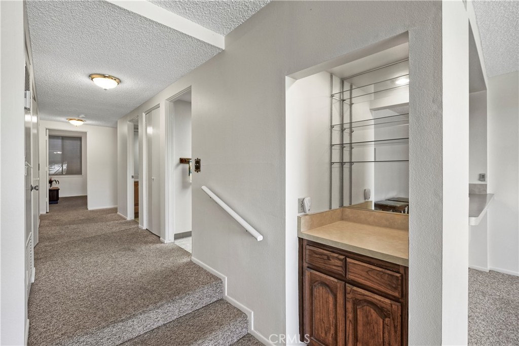 5555 Canyon Crest Drive, Unit 1F Riverside, CA 92507 - Photo 13 of 27 a view of a hallway to rooms and stairs
