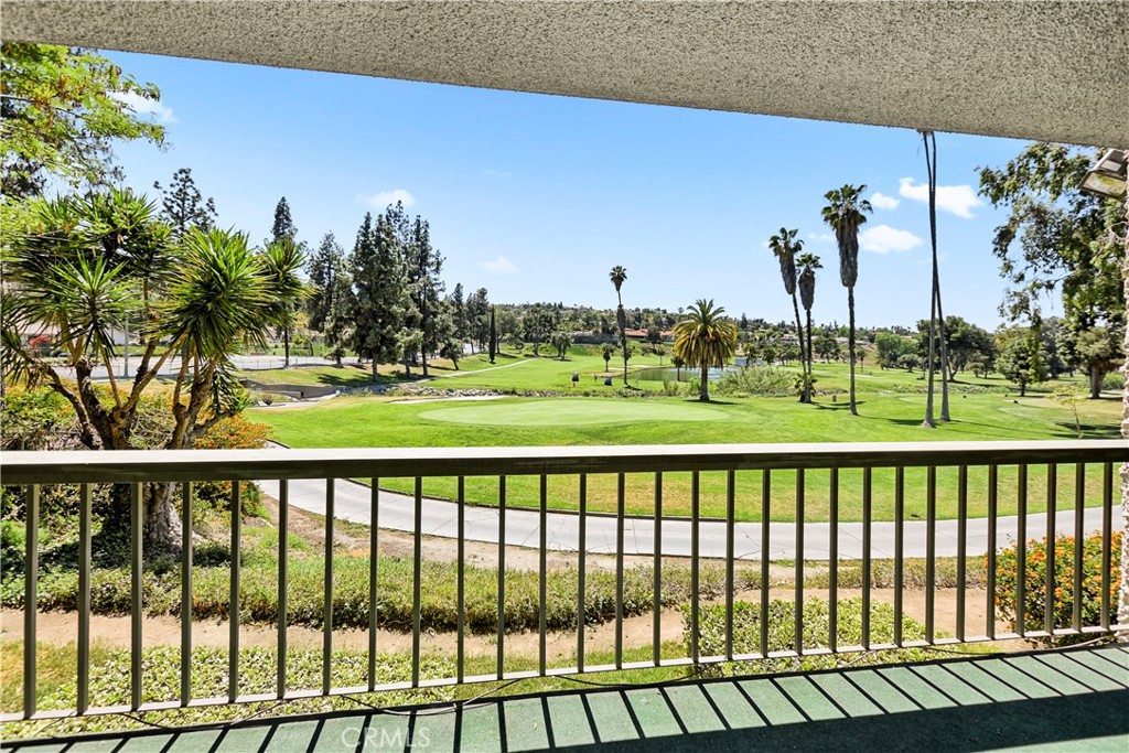 5555 Canyon Crest Drive, Unit 1F Riverside, CA 92507 - Photo 19 of 27 a view of a swimming pool and a yard