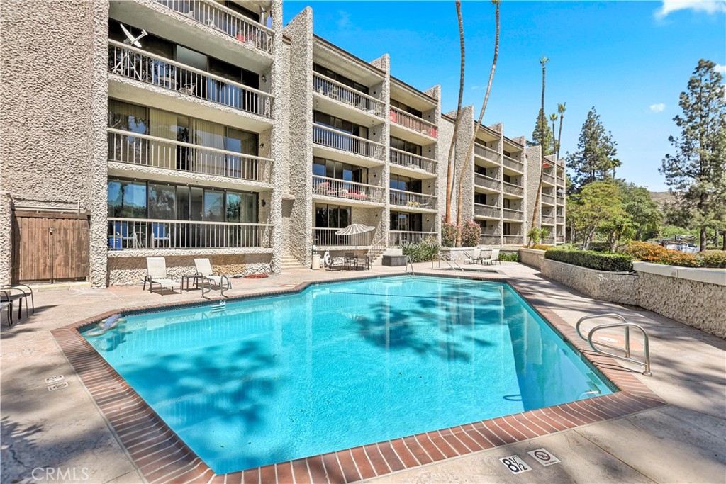 5555 Canyon Crest Drive, Unit 1F Riverside, CA 92507 - Photo 21 of 27 a swimming pool with outdoor view