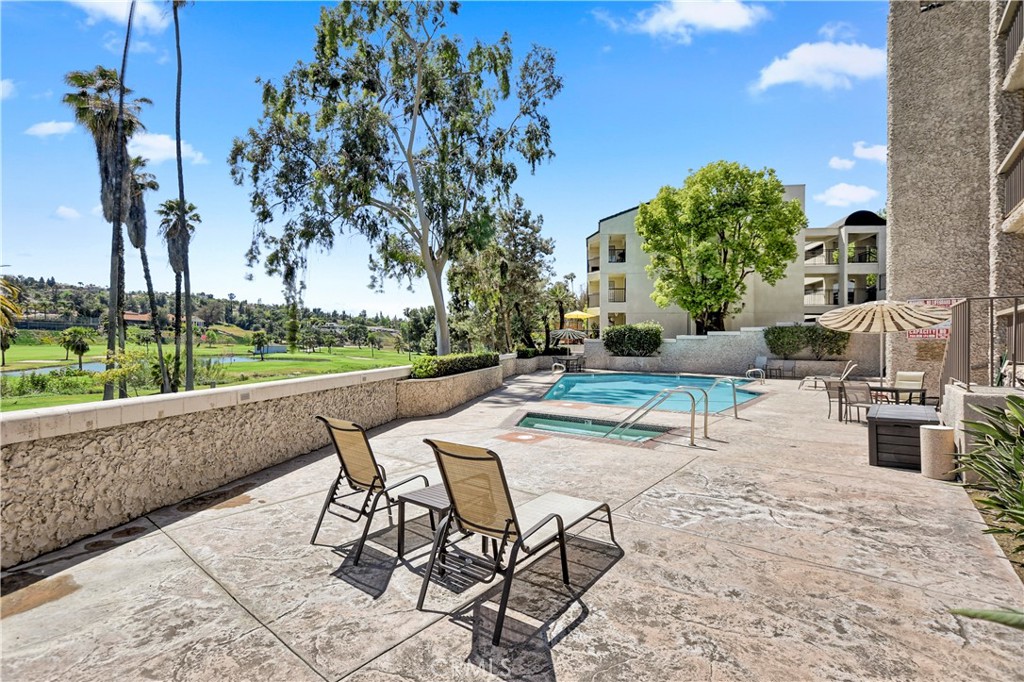 5555 Canyon Crest Drive, Unit 1F Riverside, CA 92507 - Photo 22 of 27 a view of a backyard with sitting area