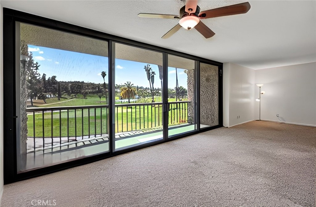 5555 Canyon Crest Drive, Unit 1F Riverside, CA 92507 - Photo 3 of 27 a view of a room with balcony and ceiling fan