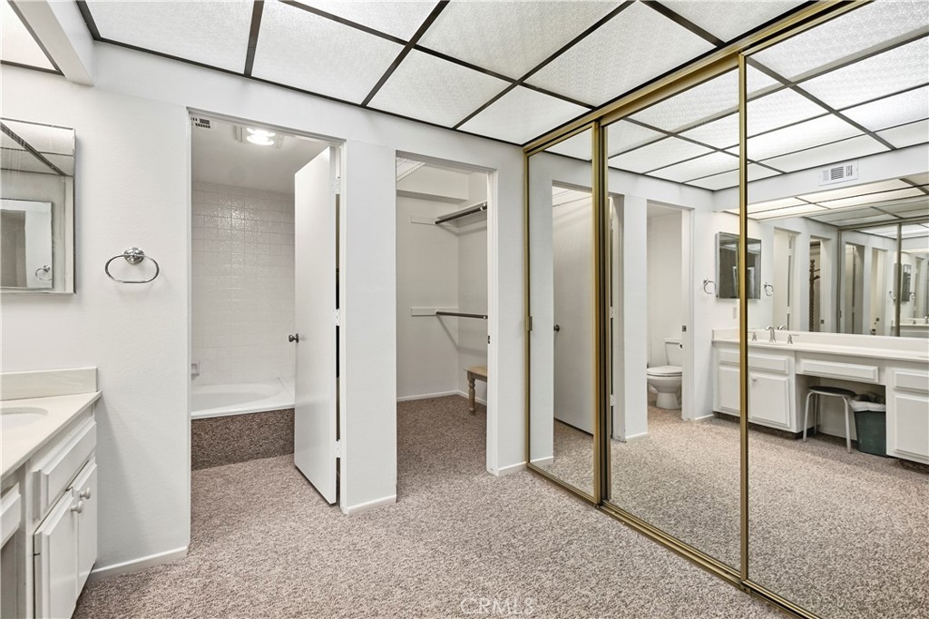 5555 Canyon Crest Drive, Unit 1F Riverside, CA 92507 - Photo 10 of 27 a view of a bathroom with a shower and a sink