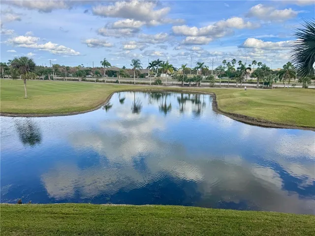 a view of a lake with houses in the back