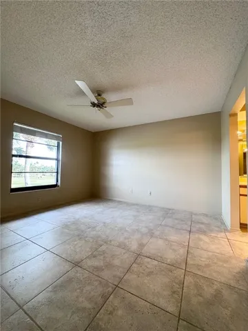 a view of a livingroom with a ceiling fan and window