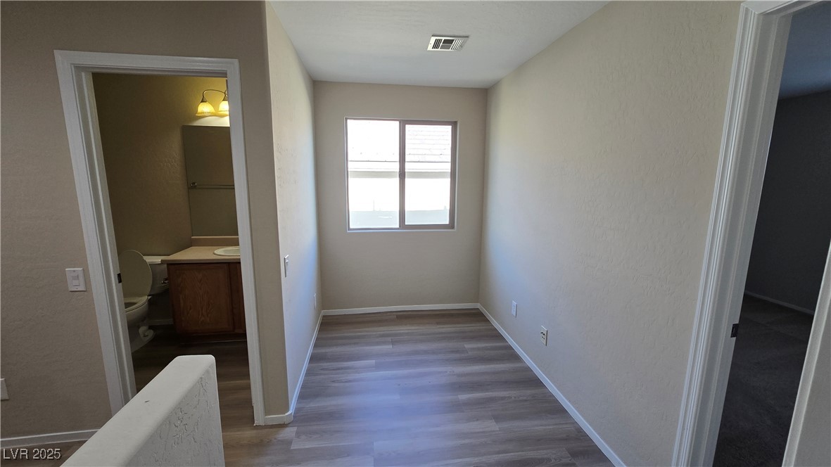 2737 Rimbaud Street Henderson, NV 89044 - Photo 26 of 49 Hall featuring baseboards, visible vents, and wood finished floors