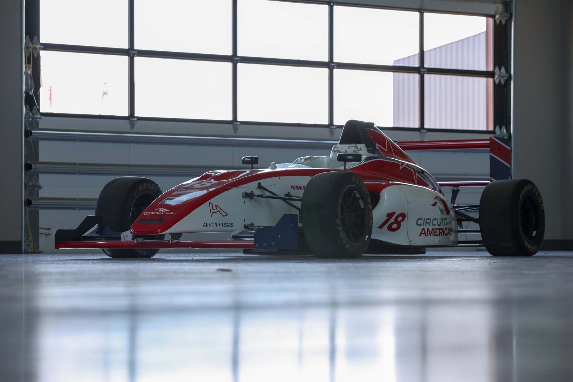 8001 Circuit Of The Americas Boulevard, Unit 502 Del Valle, TX 78617 - Photo 12 of 18 a view of a car in a garage