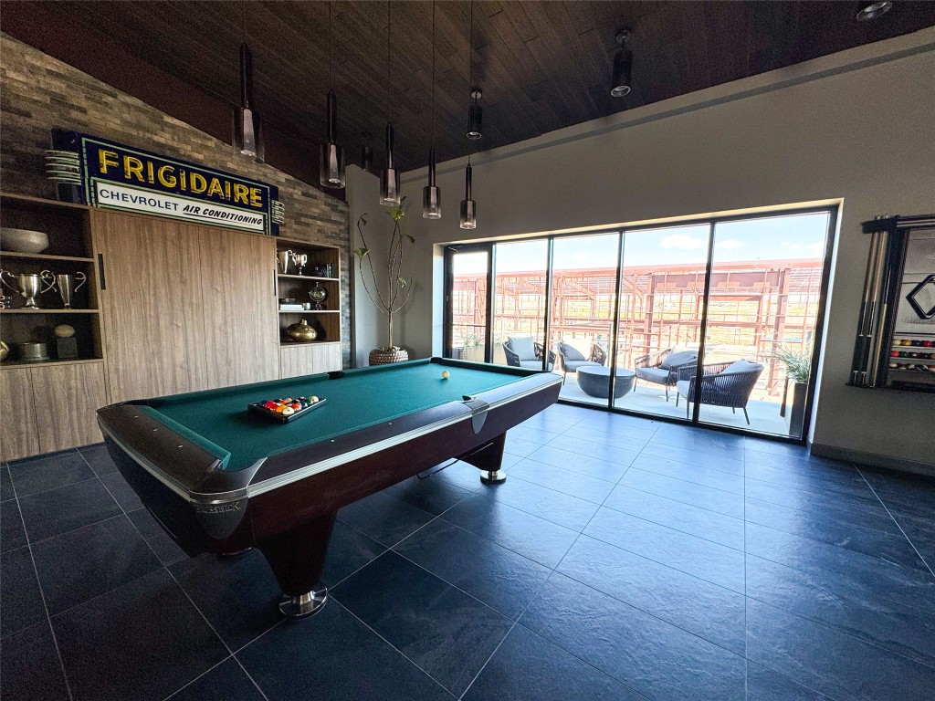 8001 Circuit Of The Americas Boulevard, Unit 502 Del Valle, TX 78617 - Photo 9 of 18 a room with wooden floor pool table and windows