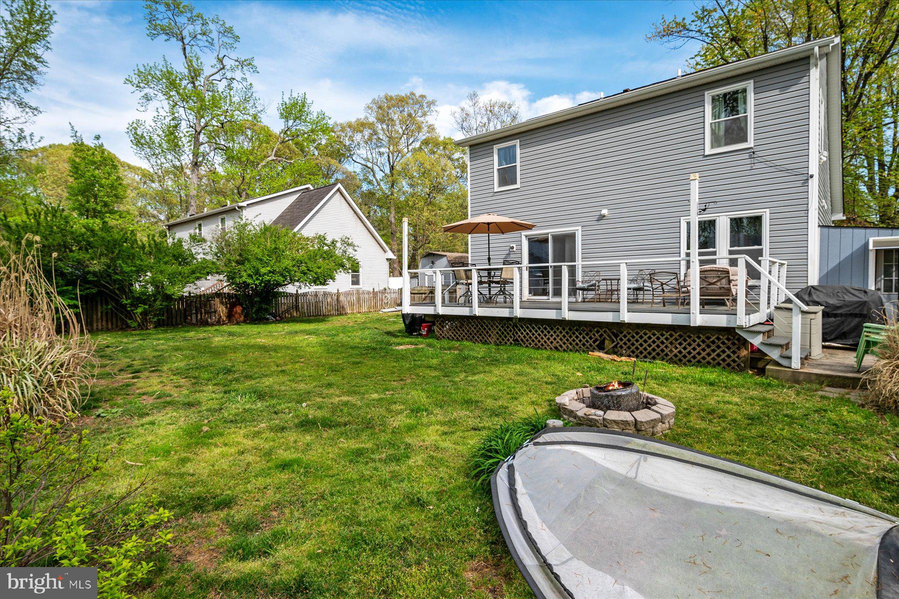 4904 Beech Street Shady Side, MD 20764 - Photo 13 of 26 a view of a house with a backyard porch and sitting area