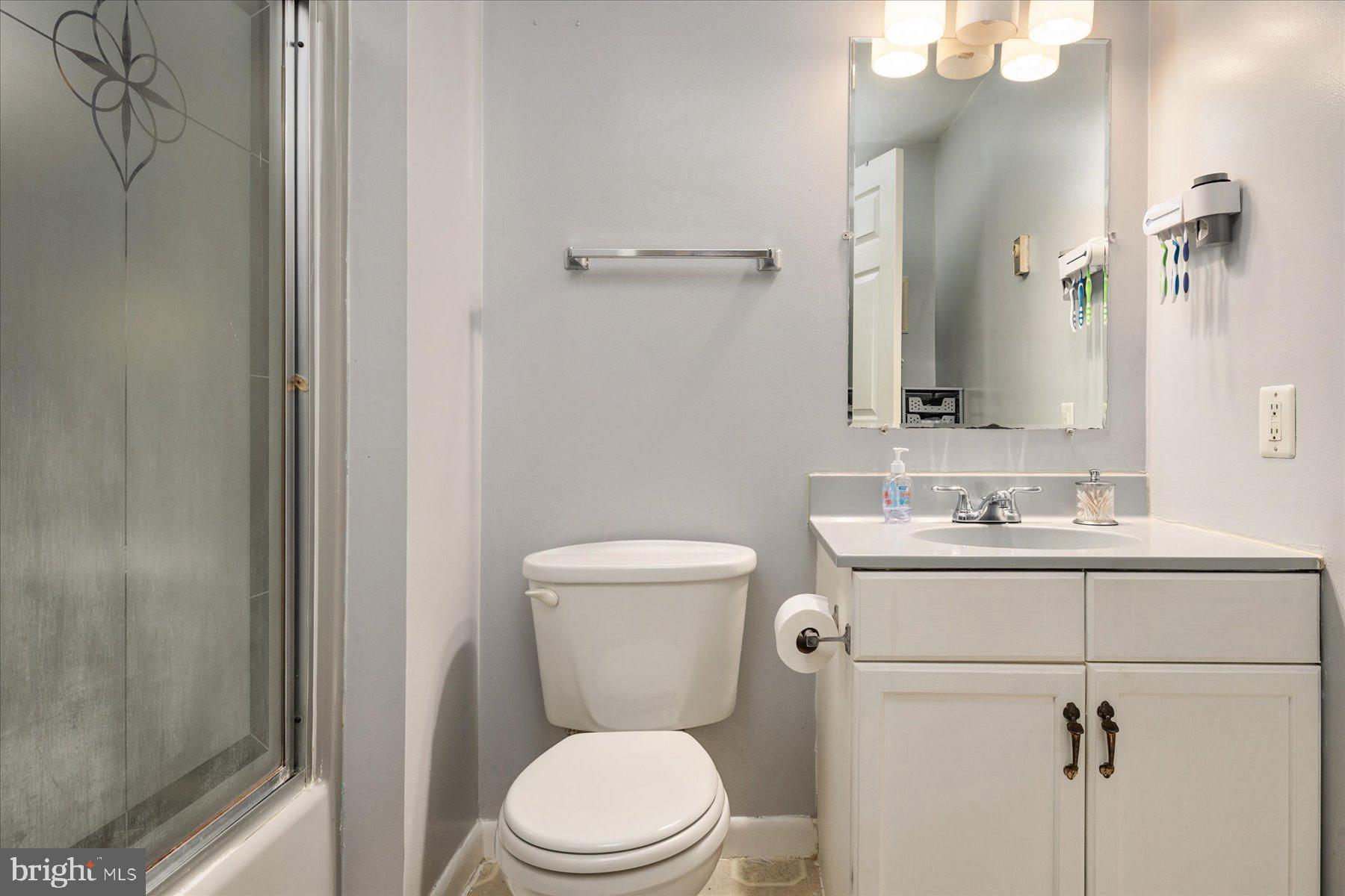 4904 Beech Street Shady Side, MD 20764 - Photo 17 of 26 a bathroom with a toilet a sink and mirror