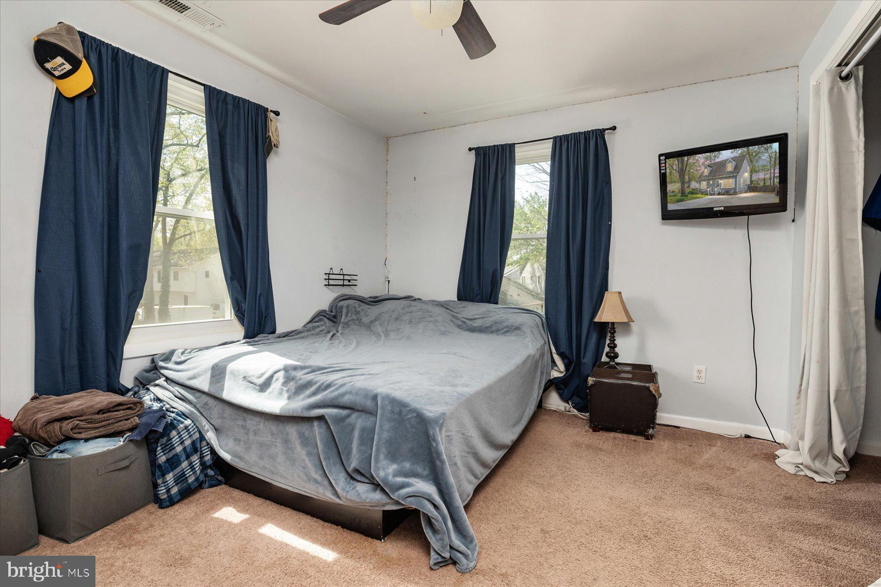 4904 Beech Street Shady Side, MD 20764 - Photo 18 of 26 a bedroom with a bed and a flat tv screen