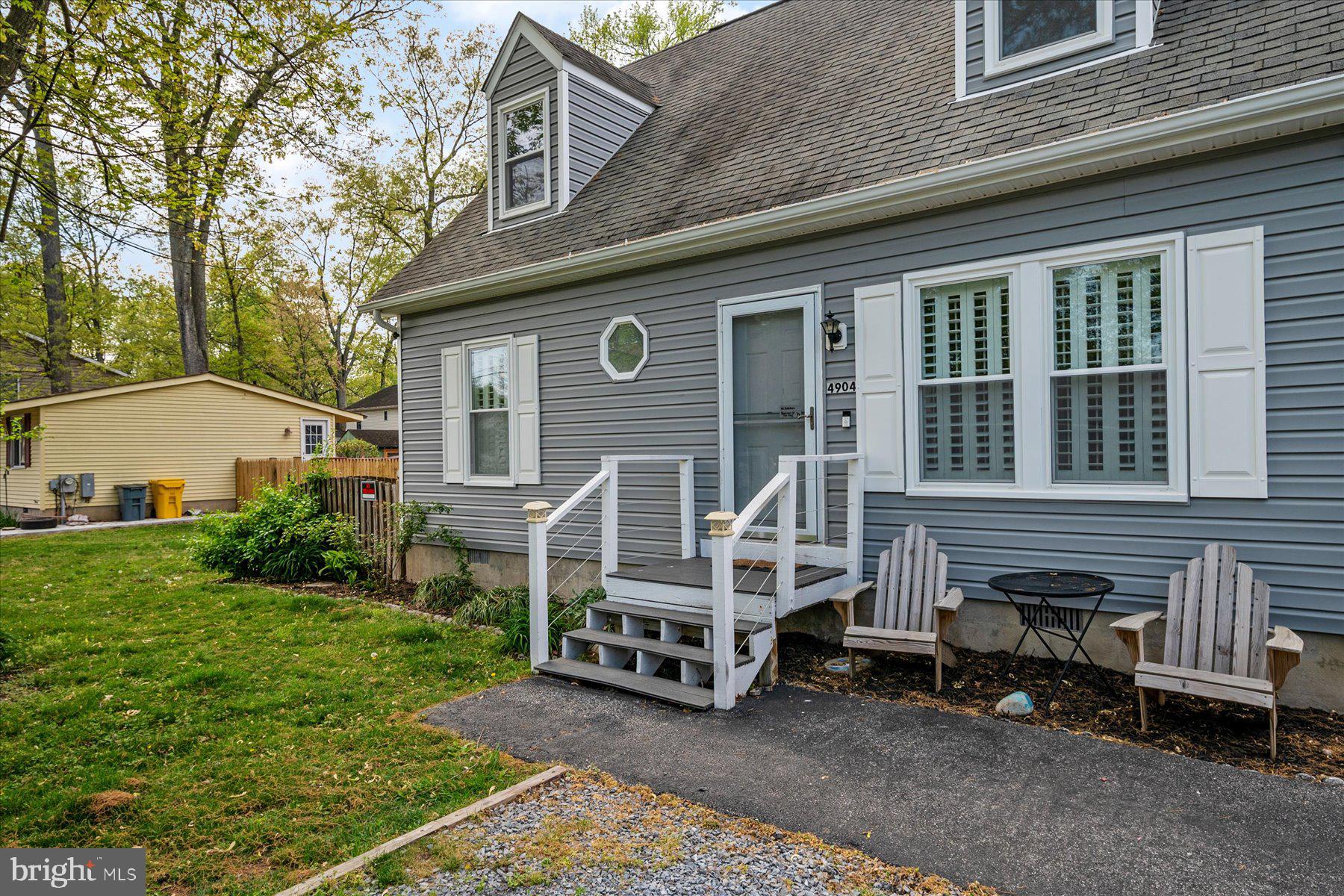 4904 Beech Street Shady Side, MD 20764 - Photo 2 of 26 a wooden bench sitting in front of a house