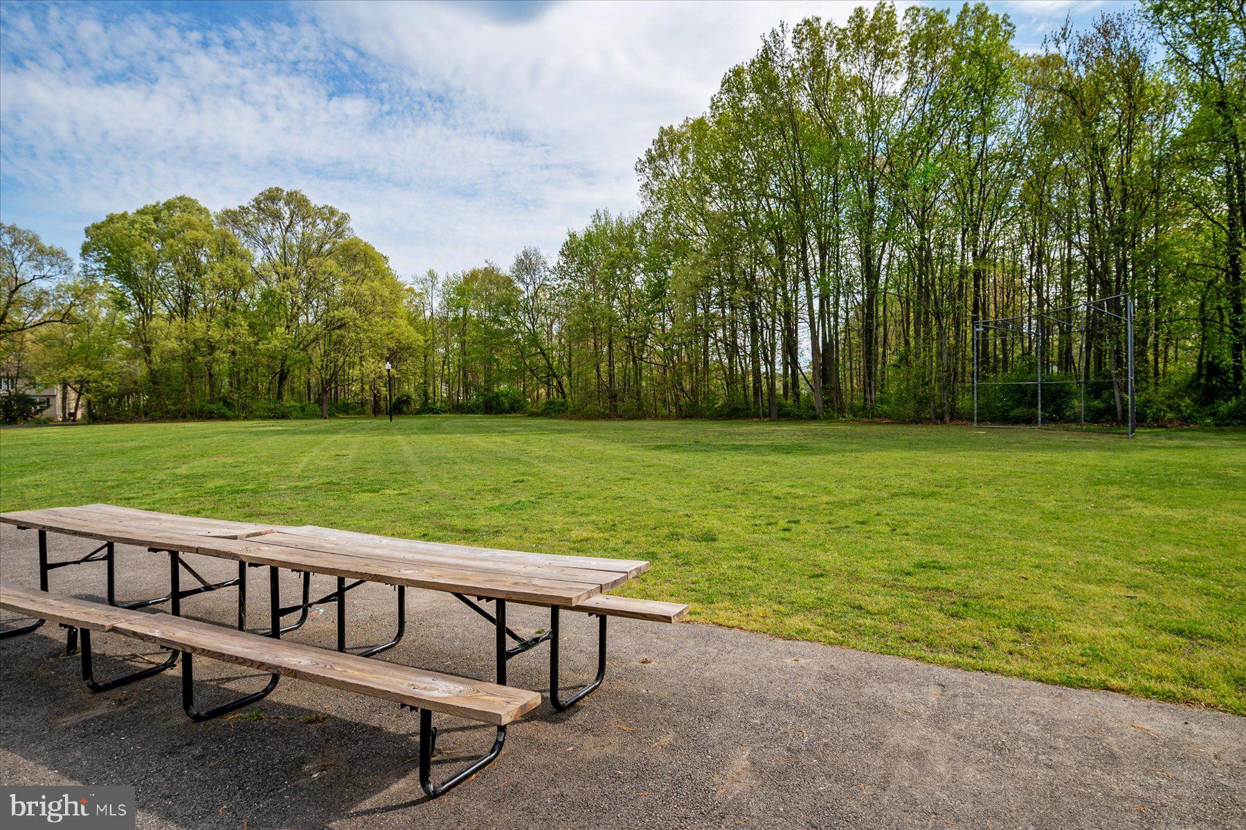 4904 Beech Street Shady Side, MD 20764 - Photo 25 of 26 a view of a bench in the garden near a lake