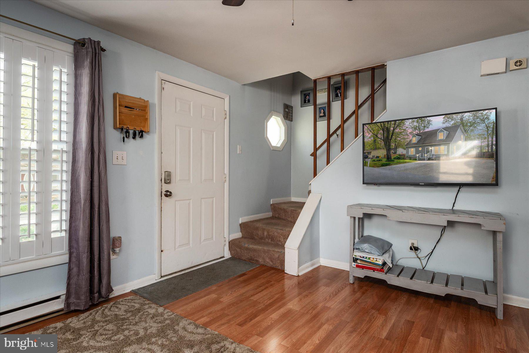 4904 Beech Street Shady Side, MD 20764 - Photo 5 of 26 a living room with furniture and a flat screen tv