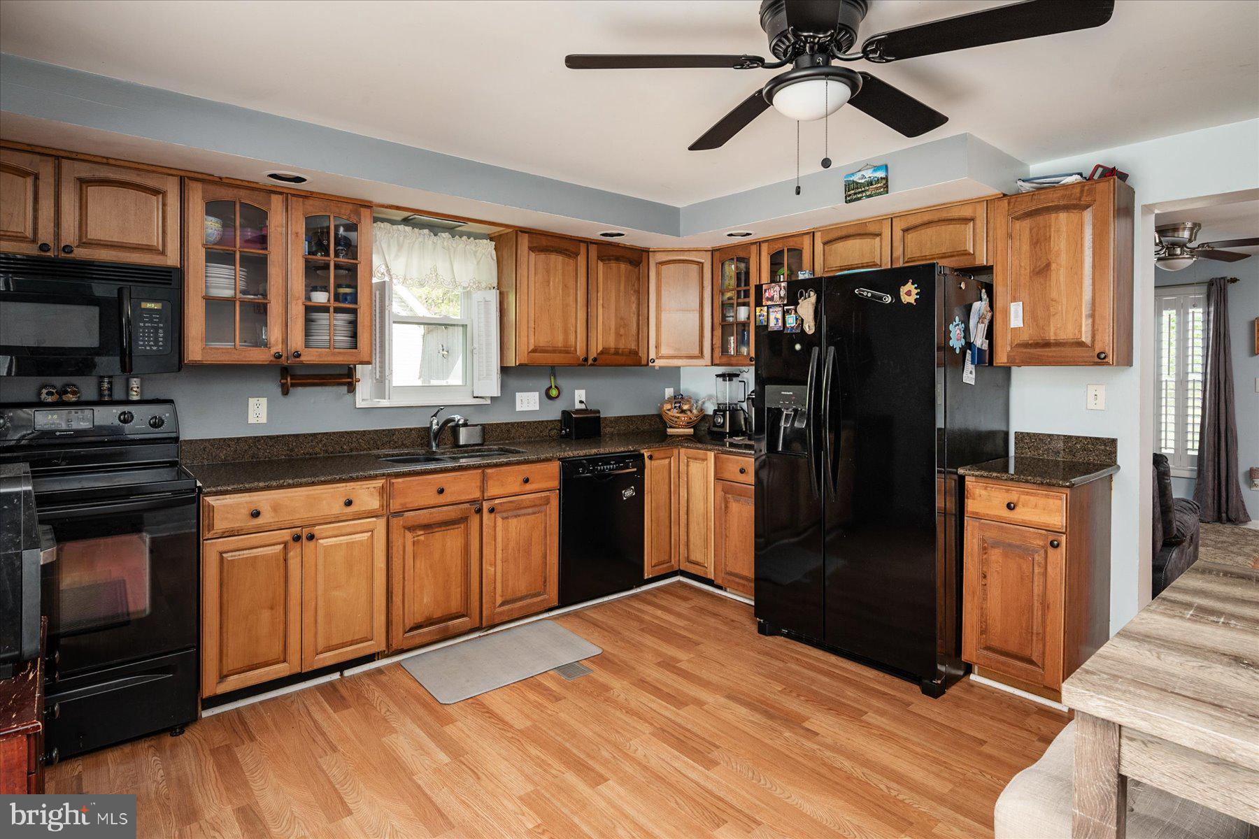 4904 Beech Street Shady Side, MD 20764 - Photo 9 of 26 a kitchen with granite countertop a refrigerator stove top oven and sink
