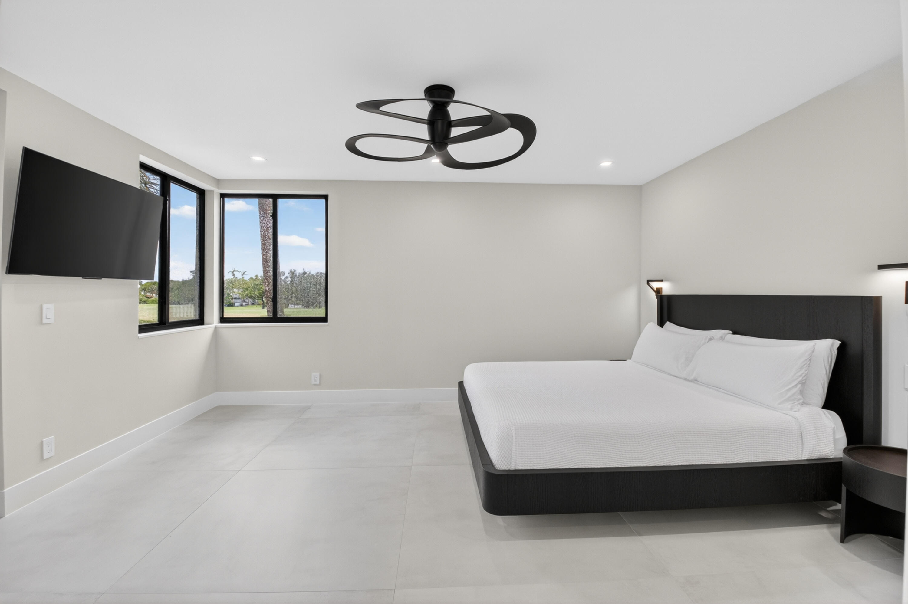 19221 Sabal Lake Drive, Unit 5124 Boca Raton, FL 33434 - Photo 29 of 98 a bedroom with a bed and a flat screen tv