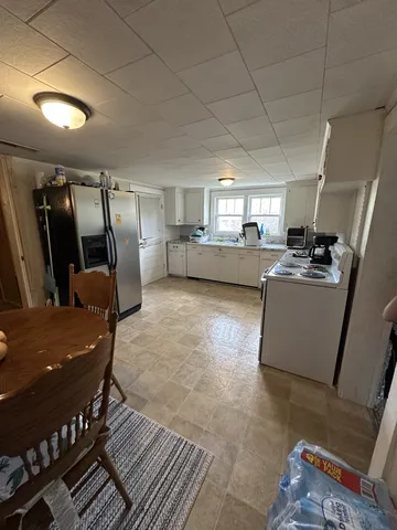 a view of a livingroom with furniture and a potted plant