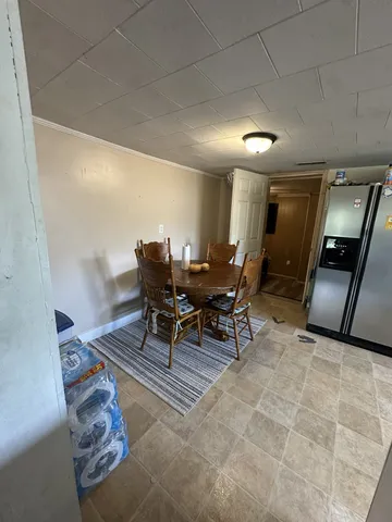 a large white kitchen with stainless steel appliances granite countertop a sink and cabinets